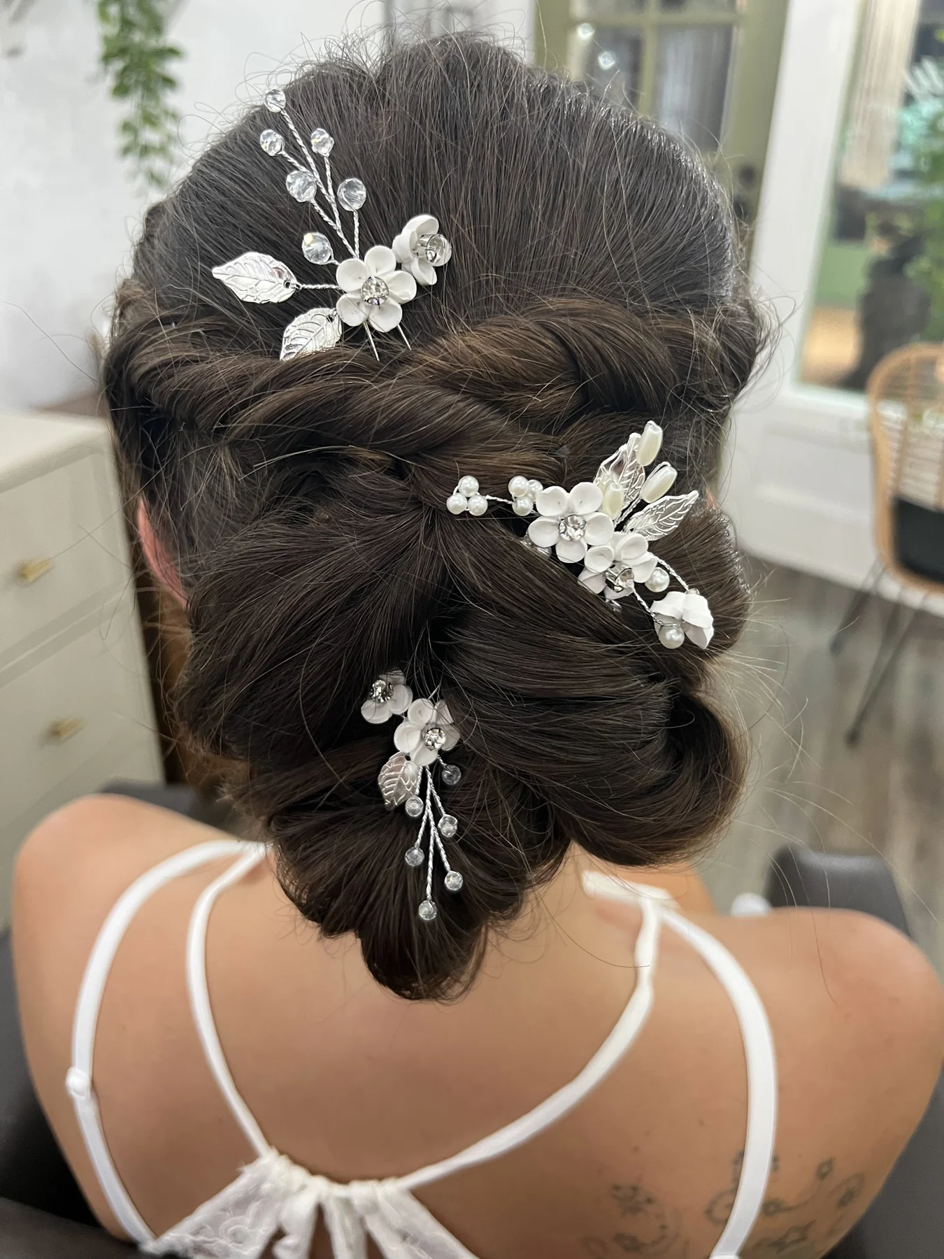 A finished pinned updo by Kelley, viewed from behind