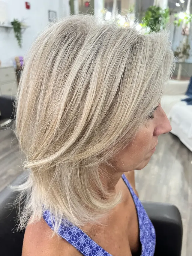 A layered blonde haircut finished by Kelley