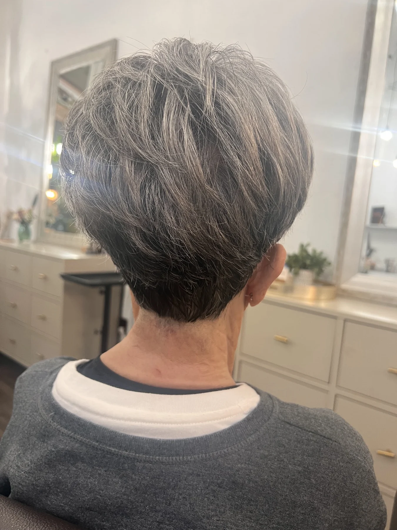 Back view of short silver-white hair with a softly shaped cut